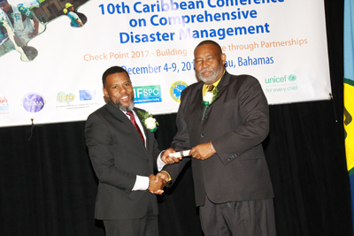 Mr Ronald Jackson, Executive Director of CDEMA (left) presenting the CDEMA Lifetime Achievement Award to Mr. Philmore Mullin, Director of the National Office of Disaster Services, Antigua and Barbuda. 
