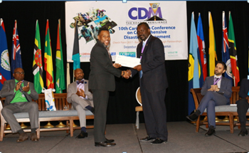 Mr. Ronald Jackson, Executive Director, CDEMA (left) presenting the cheque to the Hon. Vaden Williams, Minister of Home Affairs, Transportation and Communication with responsibility for disaster management, Turks and Caicos Islands.