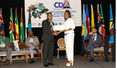 Dr. Evangeline Inniss-Springer, Deputy Director, Department of Disaster Management of the British Virgin Islands accepting cheque being presented by Mr Ronald Jackson, Executive Director, CDEMA. 