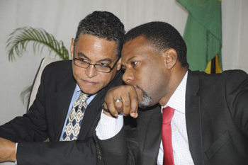 Executive Director, CDEMA, Ronald Jackson in discussion with The Honourable Noel Arscott, Minister of Local Government and Community Development.