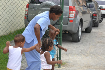  caregiver safely evacuates toddlers to designated assemble point
