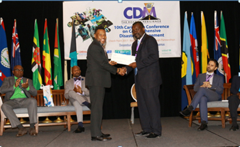 Mr. Ronald Jackson, Executive Director, CDEMA (left) presenting the cheque to the Hon. Vaden Williams, Minister of Home Affairs, Transportation and Communication with responsibility for disaster management, Turks and Caicos Islands.